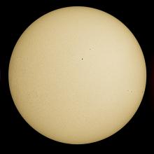 Three disk views of the Sun. The left disk reveals sunspots (dark spots) and phages (light clouds surrounding the darkspots) visible in the Sun's atmosphere. The middle disk reveals the Sun's surface, with a few sunspots visible as dark spots. Similar to the left disk, the right disk reveals the Sun's atmosphere. Sunspots are visible as dark spots surrounded by lighter phage clouds, but prominences are also visible as gases float off the edges of the disk.