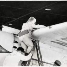 Wiley Post Climbing into the Winnie Mae with his Pressure Suit