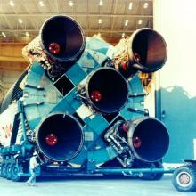 Bottom-facing view of a Saturn V rocket, focusing on five large engines.