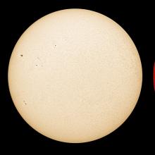 Three disk views of the Sun, side by side. The first disk reveals sunspots (dark spots) and phages (lighter-colored spots). The second disc shows the surface of the Sun with a couple of sunspots visible as dark spots. The third disc reveals the Sun's atmosphere,  with sunspots as dark spots surrounded by lighter-colored phages, and a prominence of gas floating away from the atmosphere on the upper right side of the disk.