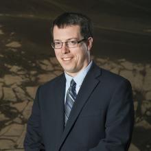 Dr. Ross Irwin, a white male geologist, poses for a portrait.