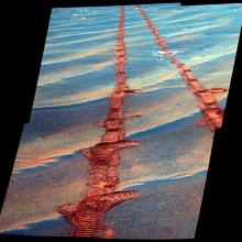 A set of tracks left by the Opportunity Rover as it traverses sand dunes on Mars.