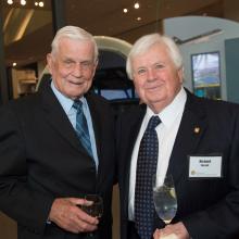 Richard Russell and Col. Bud Anderson, both white men, stand together at a lecture hosted by the museum.