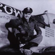 Col. Clarence E. "Bud" Anderson, USAF (Ret.), a white man, poses on the wing of an airplane.