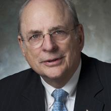 Norm Augustine, a white man, poses for a portrait.