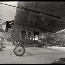 Side view of a monoplane with one engine on display in its prior home in the Smithsonian Castle.