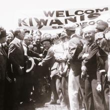 Pilots John Macready and Oakley Kelly, both male, receive a celebration after landing the T-2 plane.