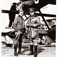 Jimmy Doolittle and Lt. Cyrus Bettis, both of whom are white male pilots, stand together under an aircraft.