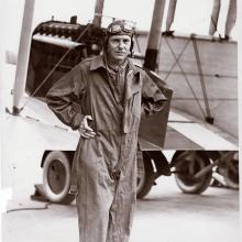 Ross Rowell, a white male pilot, poses for a portrait wearing aviator gear.