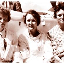 Amelia Earhart, Ruth Nichols, and Louise Thaden, all of whom are white women, sit together.