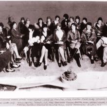 A large group of women pilots sit together.