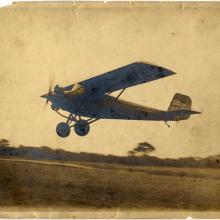 Monoplane with one engine. Monoplane is slightly above the ground.