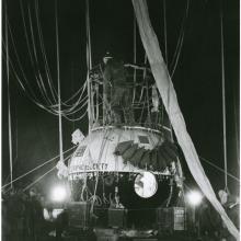 Close-up view of the large gondola of an air balloon with a light and dark colored base.