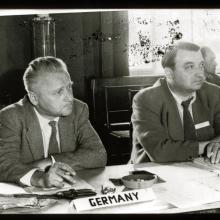 Eugen Sänger, a white male engineer, sits at a table near others.