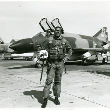 Daniel James Jr., an African-American male, poses formally in front of an aircraft.