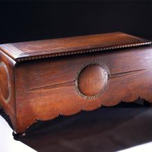 Wooden chest commissioned to hold the trophies, plaques, and memorabilia belonging to Amelia Earhart. The chest features motifs highlighting three of Earhart's milestone flights.