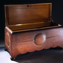 Opened wooden chest commissioned to hold the trophies, plaques, and memorabilia belonging to Amelia Earhart. The chest features motifs highlighting three of Earhart's milestone flights.