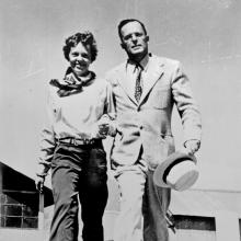 Amelia Earhart and George Palmer Putnam, a white woman and man respectively, pose informally.