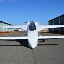 Front view of white monoplane with long tailplane and fin combo.