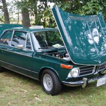 Side view of teal, four-door sedan automobile.