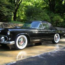 Side view of black, vintage two-door automobile.