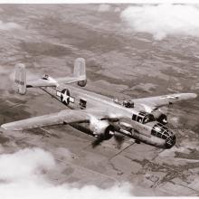 A bomber monoplane with twin engines in flight. Painting of a star near the rear of the fuselage indicates its status as a military monoplane.