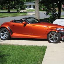 Side view of red, two-seat convertible automobile with two doors.