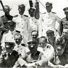 An informal photo of the original U.S.S. Langley pilots, who are in uniform. In the back row, Alfred Melville Pride stands second from the right and Godfrey Chevalier stands in the center.