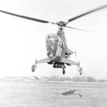 Front view of a helicopter with a three-blade propellor. 