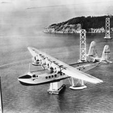 <em>Pan American Clipper</em> over San Francisco-Oakland Bay Bridge