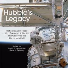 Book cover featuring a partial view of the Hubble Space Telescope in orbit as an astronaut performs a spacewalk next to the telescope. The book title "Hubble's Legacy" is placed on a solar panel that is perpendicular to the rest of the visible telescope.