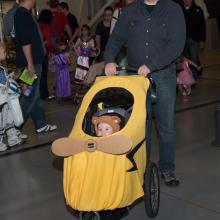 An infant is dressed up in a Piper Cub-inspired Halloween costume during the Museum's annual Halloween event.