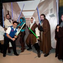 A Museum volunteer poses with people dressed in Star Wars costumes at the Museum's annual Halloween event.