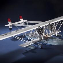 Diagonal front view of white-colored monoplane model. 