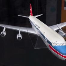 Front view of plastic commercial aircraft model with white, blue, and red livery. Northwest is painted on the side.