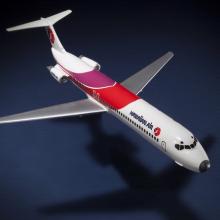 Top view of resin commercial aircraft model with white, red, and purple livery. Hawaiian Air is painted toward the front of the fuselage.