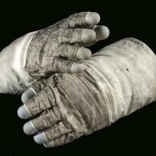 Pair of lunar gloves used on Apollo 17 mission. A special gray fabric makes up most of the gloves with the blue fingertips made from silicon rubber.