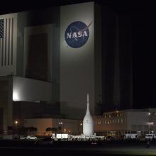 Orion Spacecraft Rolls Past the Vehicle Assembly Building