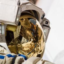 Close-up view of Cosmonaut Sergey Ryazanskiy, who is wearing his astronaut suit, during a spacewalk.