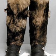 Pair of survival boots with black leather base and black and tan-brown fur on the sleeves.