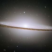 A disc-shaped galaxy that looks slightly like a sombrero.