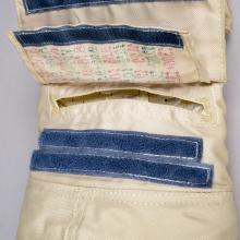 Close-up view of glove on cosmonaut suit, featuring a flap that would include a written checklist for spacewalks.