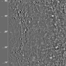 A satellite view of the Caloris Basin on Mercury. The basin features many craters of various sizes.