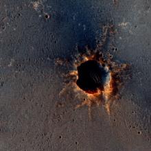 A photo of the "Santa Maria" Crater on Mars, a large crater with reddish-orange edges.