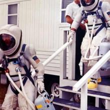 Gemini 7 prime crew leaves suiting trailer during prelaunch countdown