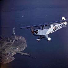 Piper J-3F Cub Flitfire over Statue of Liberty