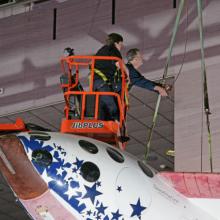 SpaceShipOne and Museum Specialists in cherry picker