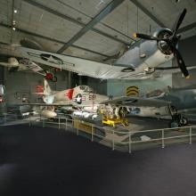 Planes are suspended in the air and sit on the floor in the Sea-Air Operations gallery.