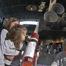 Girl Looks through Telescope at Udvar-Hazy Center