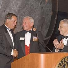 Jim Guyette, Jack Dailey and Don Lopez, three men, stand next to each other at a gala.